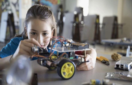 girl building motorized vehicle